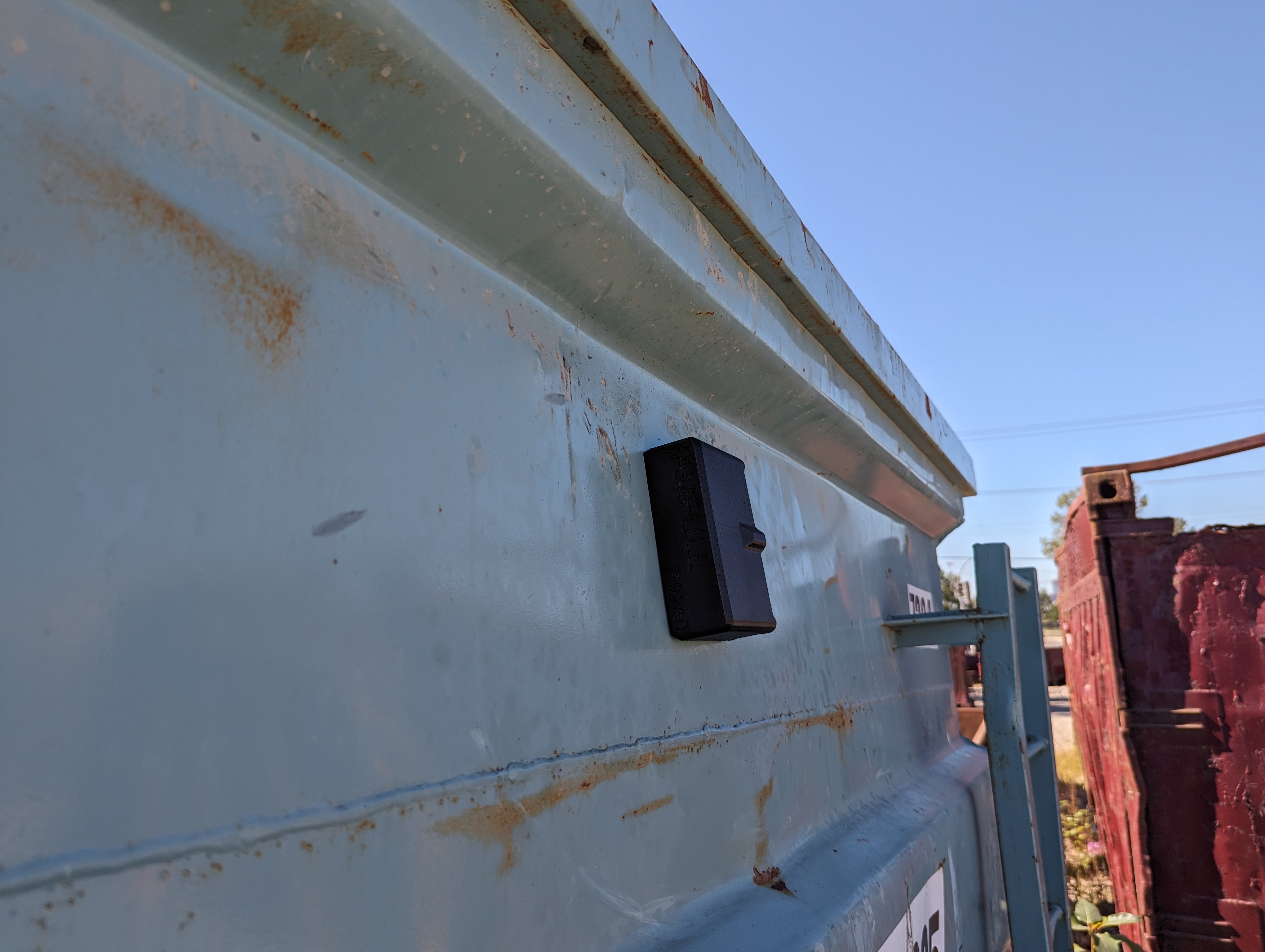 iamFull gateway mounted on the side of a roll-off bin